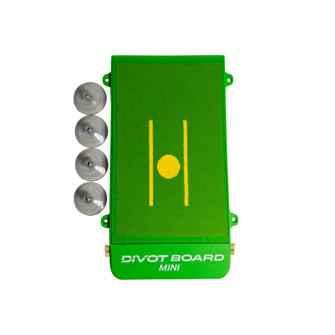 Divot Board MINI turf pad with yellow alignment lines, shown with its four suction cups lying alongside