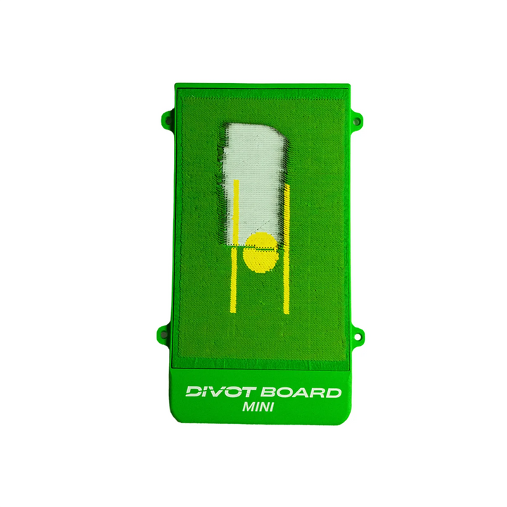 Divot Board MINI top face with a pale white strike mark swiped through the yellow ball spot