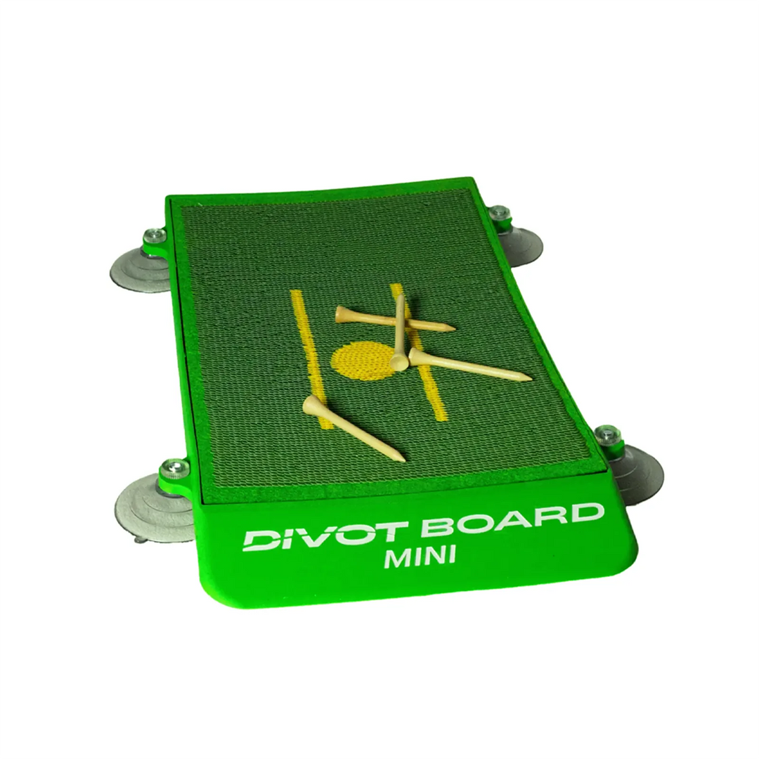 Divot Board MINI with four suction cups fitted at the corners and wooden tees on the green turf pad