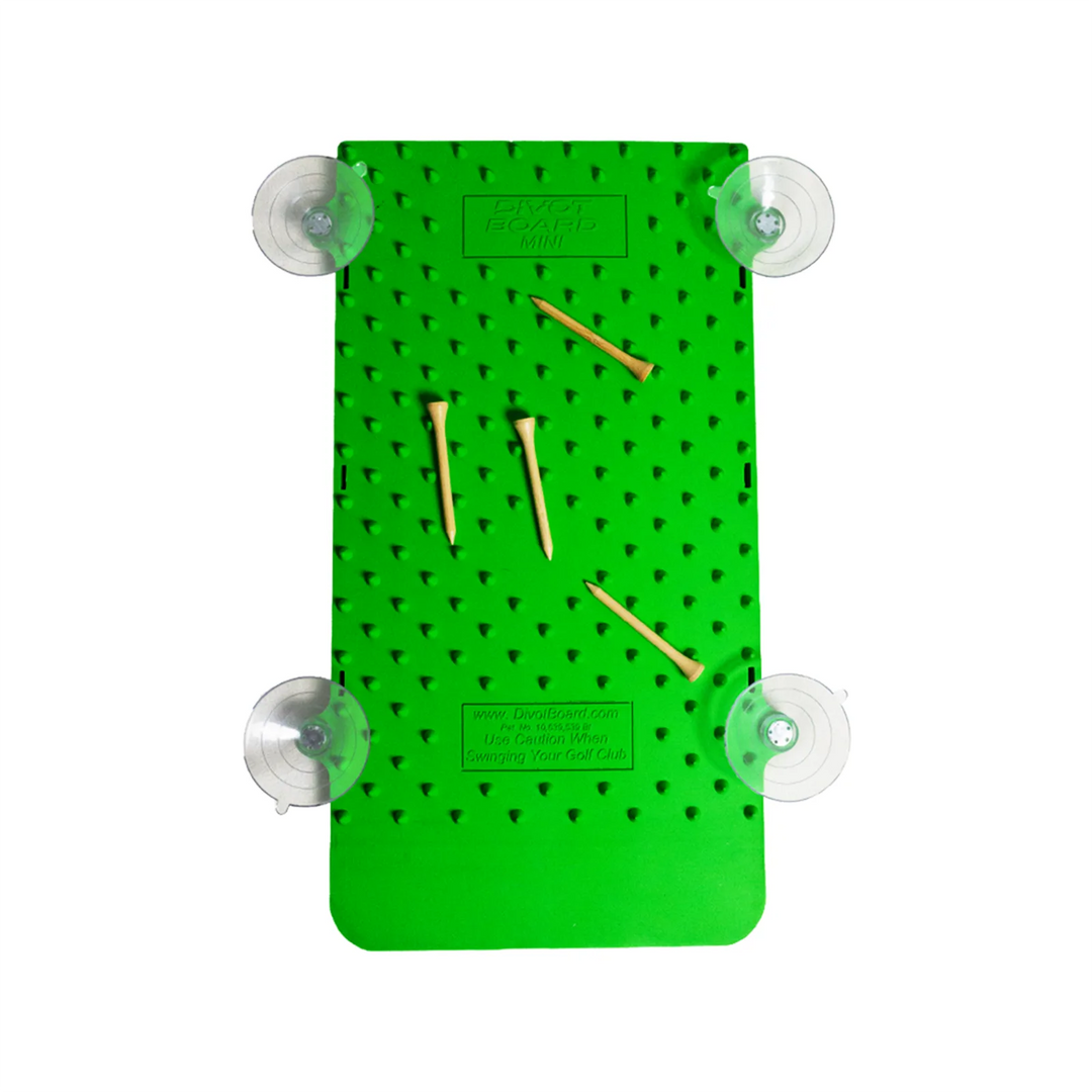 Underside of the Divot Board MINI base, studded green surface with four suction cups and wooden tees