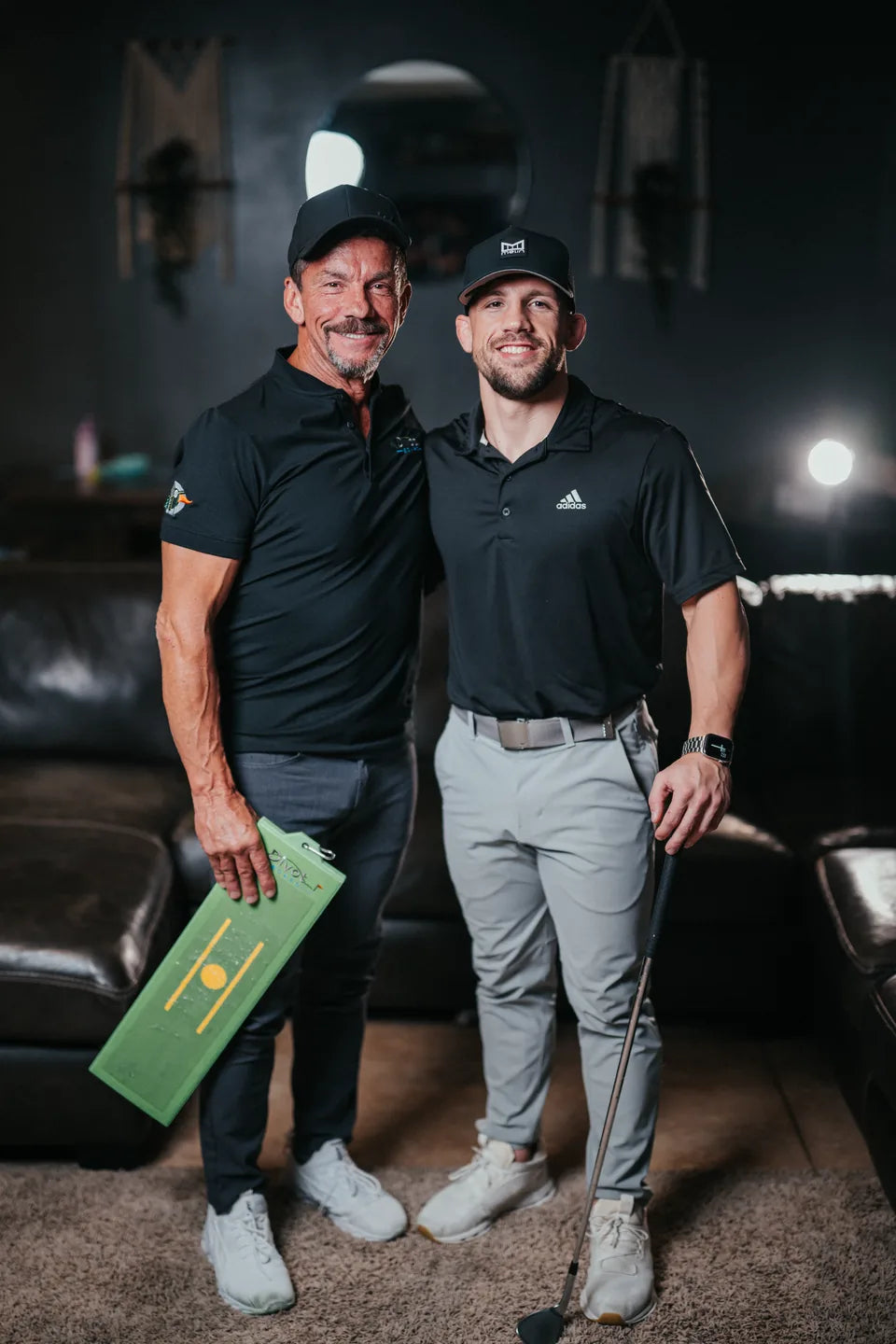 Bo Longo and his son Mike with a Divot Board and golf club